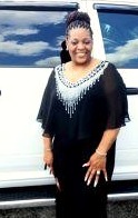 Elder Pamela McPherson, dressed for church in black with a beaded collar, smiling.